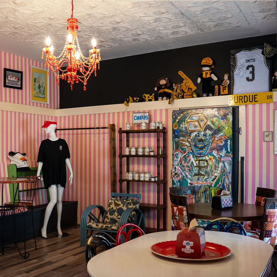The mezzanine above the candy store, with pink-striped walls, a red chandelier and Purdue memorabilia